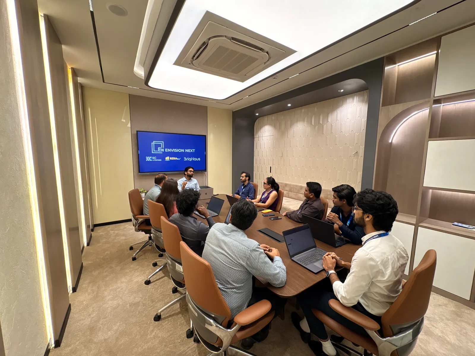 Team meeting around the boardroom table during a presentation